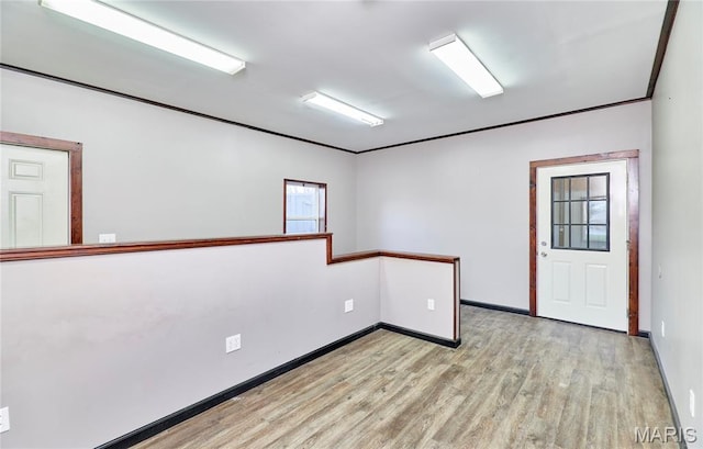 unfurnished room with light wood finished floors and baseboards