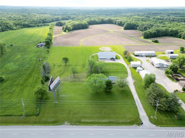 aerial view of sparsely populated area featuring a heavily wooded area