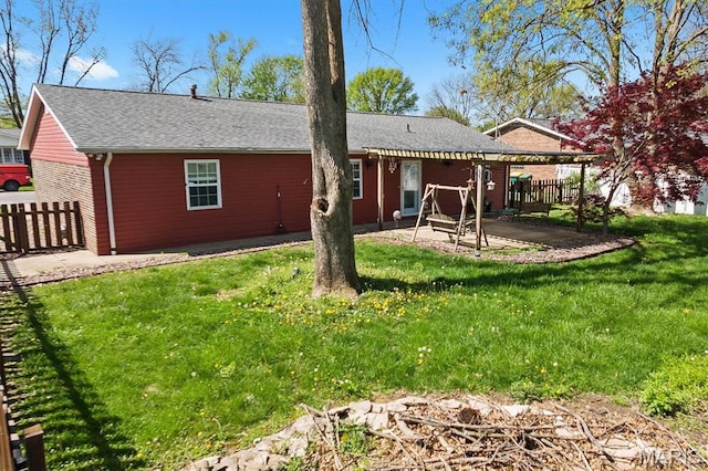 rear view of house with a patio area and a shingled roof