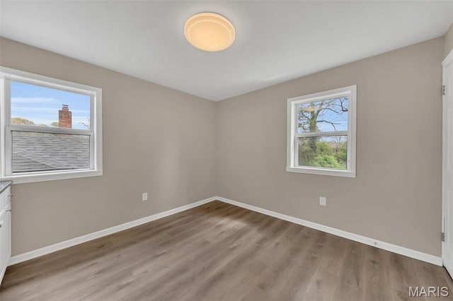6635 Donald St, Saint Louis, MO 63121 - empty room featuring baseboards and light wood-type flooring