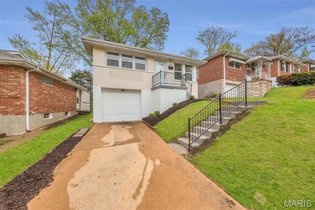 6635 Donald St, Saint Louis, MO 63121 - view of front of property with a garage, a front yard, brick siding, concrete driveway, and stairs