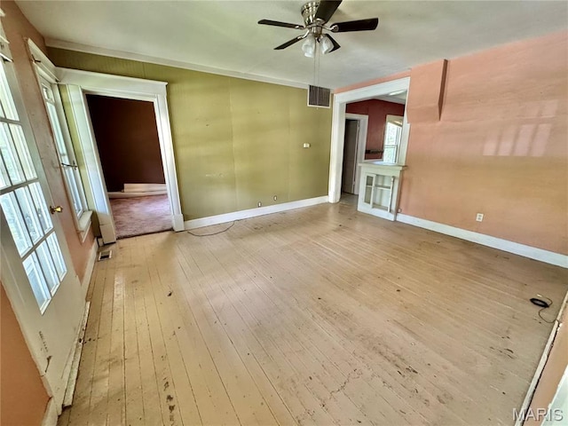 unfurnished room with light wood-type flooring, ceiling fan, and baseboards