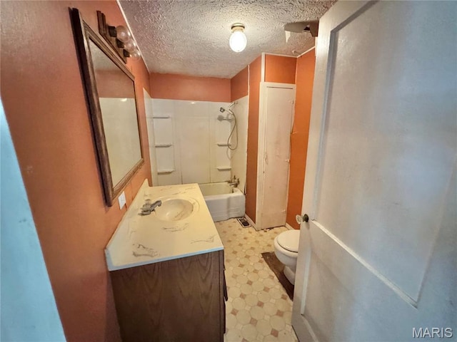 full bath with tile patterned floors, toilet, vanity, shower / tub combination, and a textured ceiling