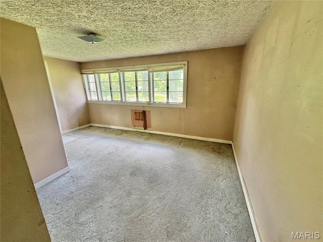 unfurnished room featuring carpet flooring and baseboards