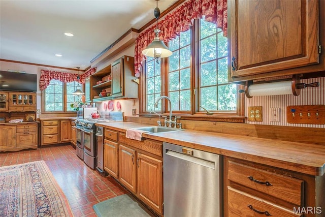 1577 Kehrs Mill Rd, Chesterfield, MO 63005 - kitchen featuring appliances with stainless steel finishes, brick patterned flooring, butcher block counters, a sink, and ornamental molding