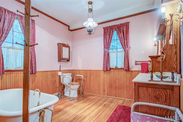 1577 Kehrs Mill Rd, Chesterfield, MO 63005 - living area featuring wood finished floors, a wainscoted wall, ornamental molding, and wood walls
