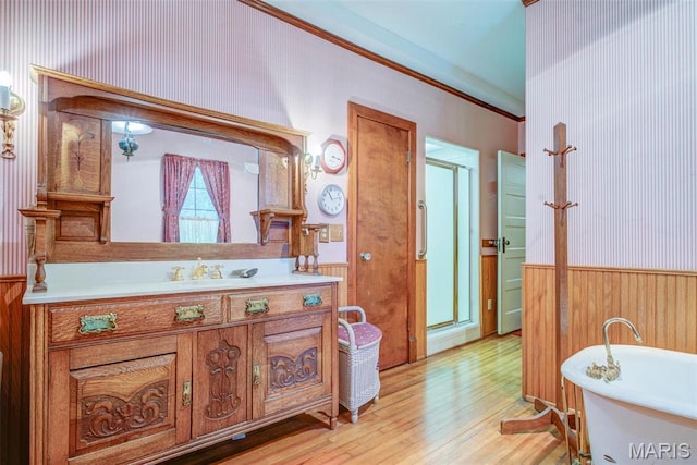 1577 Kehrs Mill Rd, Chesterfield, MO 63005 - bathroom with wood finished floors, a shower stall, a freestanding tub, vanity, and crown molding