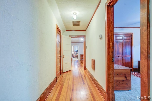 1577 Kehrs Mill Rd, Chesterfield, MO 63005 - hall featuring light wood-style flooring, crown molding, and baseboards