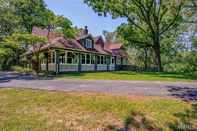 1577 Kehrs Mill Rd, Chesterfield, MO 63005 - back of house with a chimney, a yard, and a sunroom