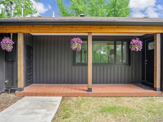 view of exterior entry with board and batten siding