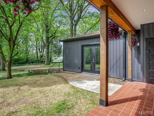 view of grassy yard with french doors