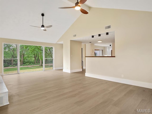 unfurnished living room with ceiling fan, high vaulted ceiling, baseboards, light wood-style flooring, and beam ceiling
