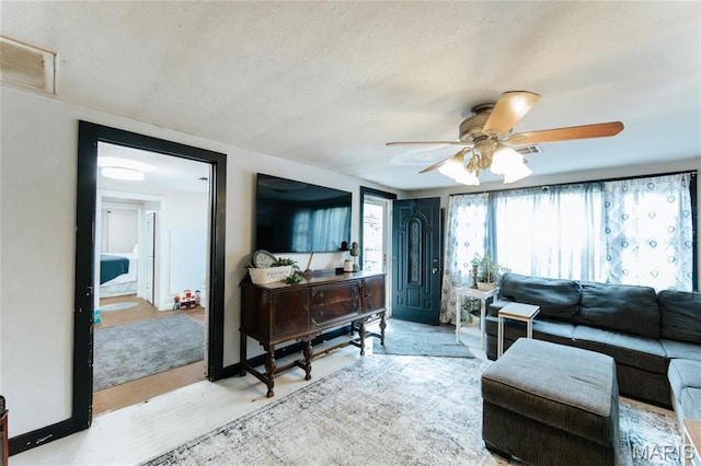 631 State Route T, Newburg, MO 65550 - living room featuring ceiling fan, a textured ceiling, and wood finished floors
