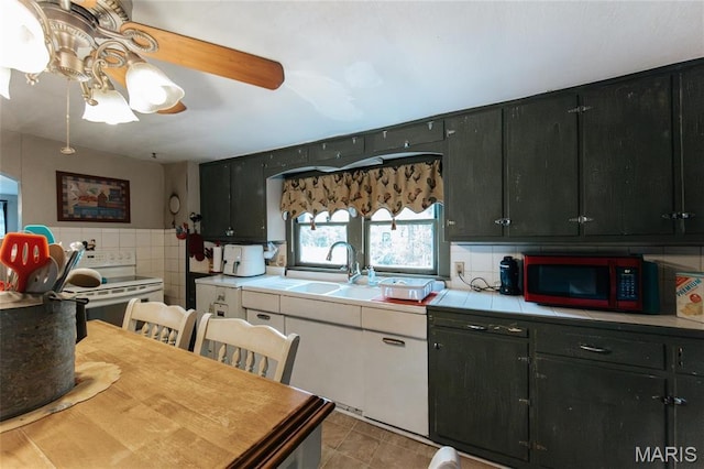 631 State Route T, Newburg, MO 65550 - kitchen with white range with electric cooktop, dark cabinetry, tile counters, and a sink