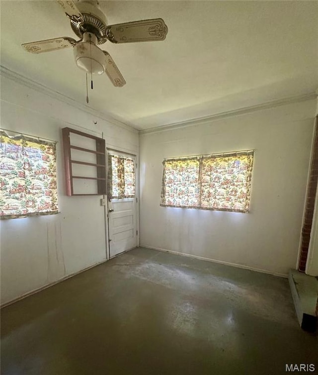1709 Korando Ave, Saint Louis, MO 63114 - spare room featuring unfinished concrete floors, crown molding, and a ceiling fan
