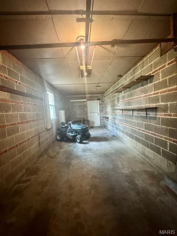 1709 Korando Ave, Saint Louis, MO 63114 - garage with concrete block wall and a garage door opener