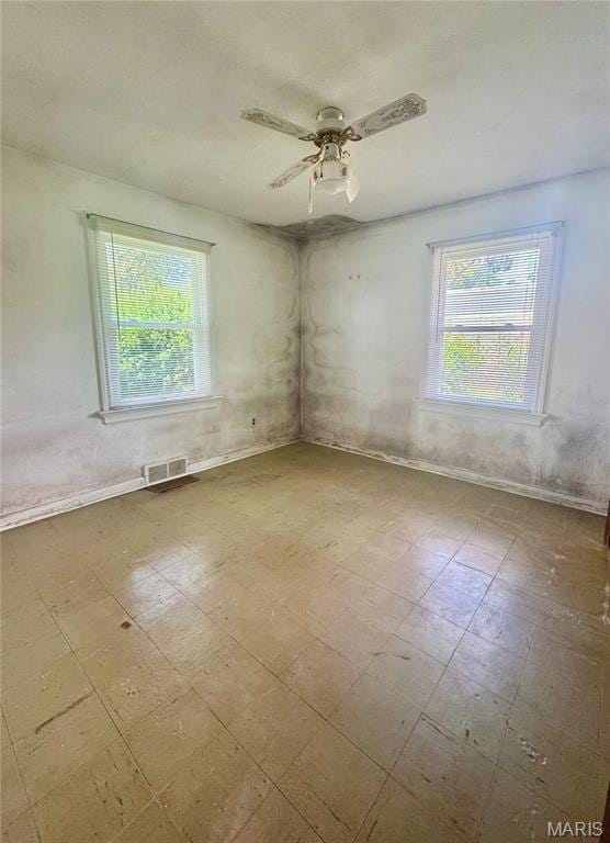1709 Korando Ave, Saint Louis, MO 63114 - unfurnished room featuring plenty of natural light, tile patterned floors, and ceiling fan