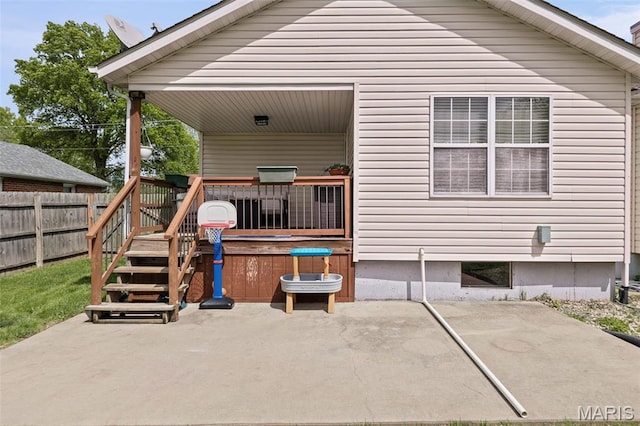 rear view of property with a patio, fence, and a wooden deck