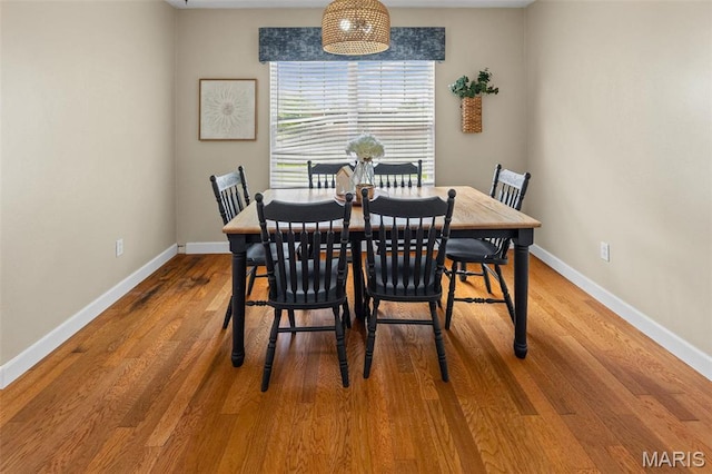 dining room with baseboards and wood finished floors