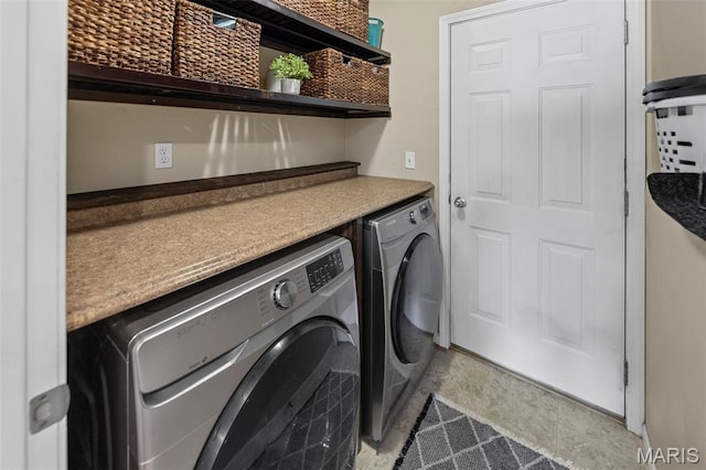 laundry room with washing machine and clothes dryer