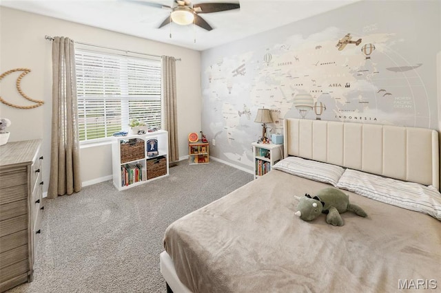 carpeted bedroom featuring baseboards and a ceiling fan