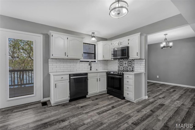 1211 Napoleon Dr, Bonne Terre, MO 63628 - kitchen featuring dishwasher, range with electric cooktop, stainless steel microwave, a chandelier, and a sink