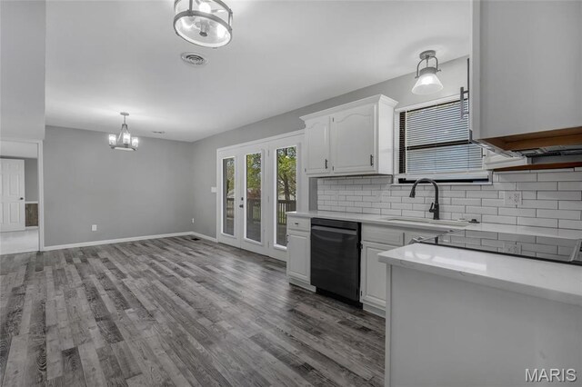 1211 Napoleon Dr, Bonne Terre, MO 63628 - kitchen featuring black dishwasher, a chandelier, light countertops, tasteful backsplash, and a sink