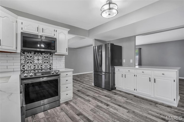 1211 Napoleon Dr, Bonne Terre, MO 63628 - kitchen with appliances with stainless steel finishes, white cabinetry, and tasteful backsplash