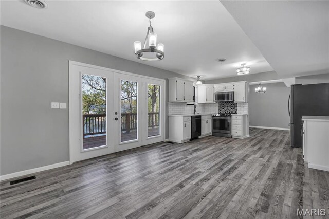 1211 Napoleon Dr, Bonne Terre, MO 63628 - unfurnished living room featuring a chandelier, wood finished floors, french doors, and baseboards