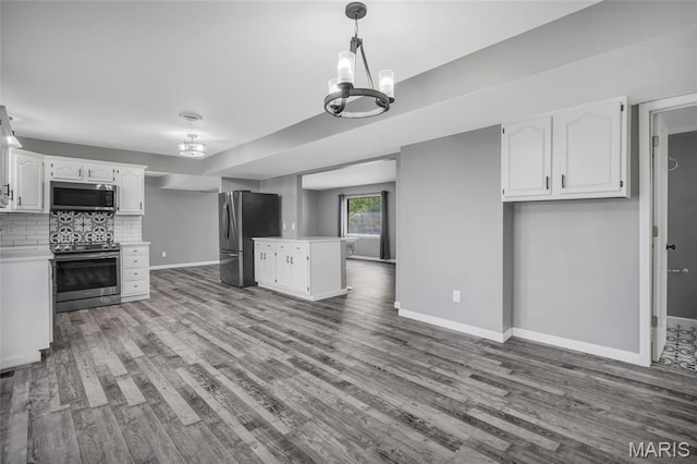 1211 Napoleon Dr, Bonne Terre, MO 63628 - kitchen featuring appliances with stainless steel finishes, a chandelier, baseboards, and wood finished floors