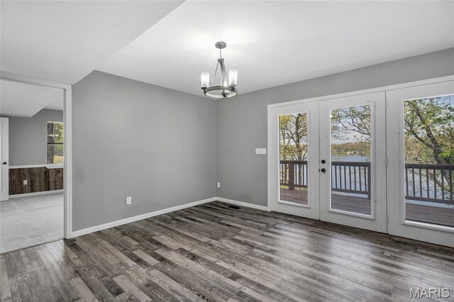 1211 Napoleon Dr, Bonne Terre, MO 63628 - unfurnished dining area with french doors, wood finished floors, a chandelier, and baseboards