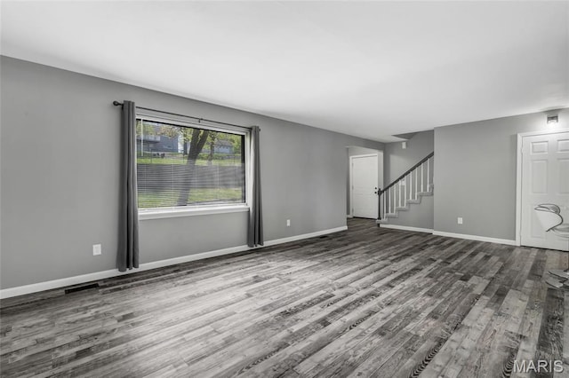 1211 Napoleon Dr, Bonne Terre, MO 63628 - unfurnished living room with wood finished floors, stairway, and baseboards