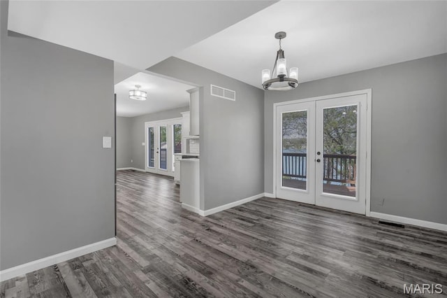 1211 Napoleon Dr, Bonne Terre, MO 63628 - unfurnished dining area with french doors, a chandelier, dark wood finished floors, and baseboards