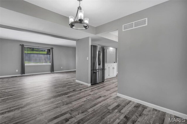 1211 Napoleon Dr, Bonne Terre, MO 63628 - unfurnished room with a chandelier, wood finished floors, and baseboards