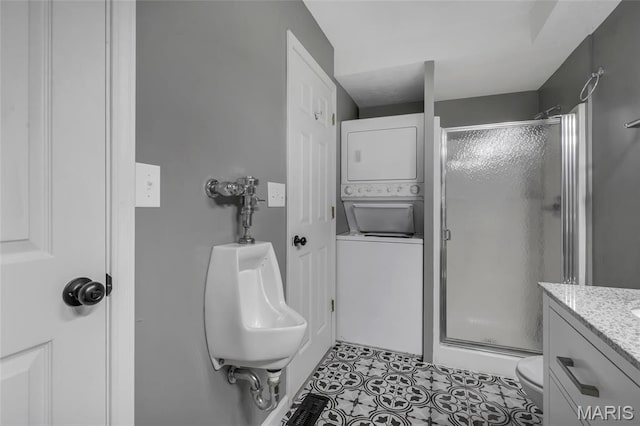 1211 Napoleon Dr, Bonne Terre, MO 63628 - bathroom featuring stacked washer / dryer, a shower stall, toilet, and tile patterned floors