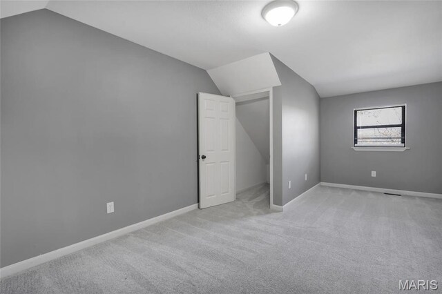 1211 Napoleon Dr, Bonne Terre, MO 63628 - unfurnished bedroom with lofted ceiling, light colored carpet, and baseboards