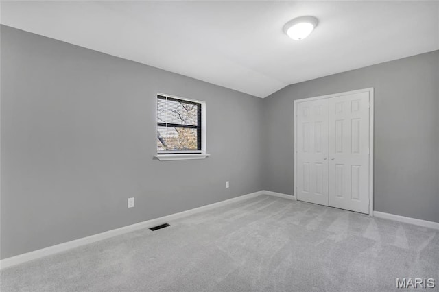 1211 Napoleon Dr, Bonne Terre, MO 63628 - unfurnished bedroom featuring carpet flooring, a closet, baseboards, and lofted ceiling