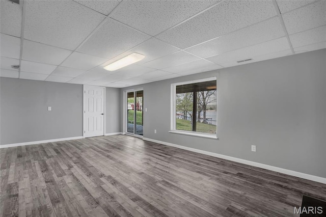 1211 Napoleon Dr, Bonne Terre, MO 63628 - unfurnished room featuring a drop ceiling, wood finished floors, and baseboards