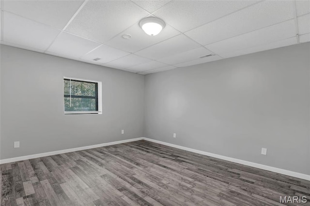 1211 Napoleon Dr, Bonne Terre, MO 63628 - unfurnished room featuring a paneled ceiling, wood finished floors, and baseboards