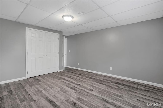1211 Napoleon Dr, Bonne Terre, MO 63628 - unfurnished bedroom with wood finished floors, baseboards, a closet, and a drop ceiling