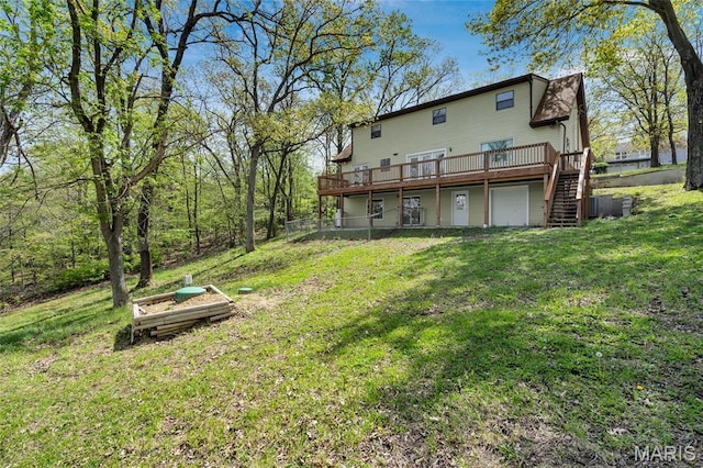 1211 Napoleon Dr, Bonne Terre, MO 63628 - back of property featuring a wooden deck, a lawn, stairs, and a garage