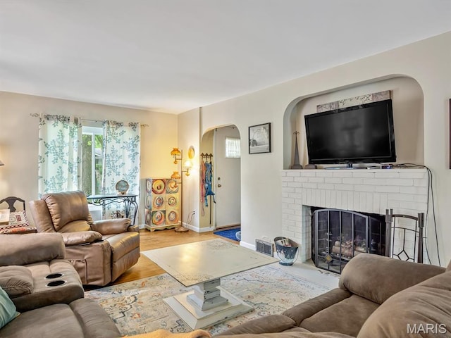 126 Sunset Ave, Collinsville, IL 62234 - living room with arched walkways, wood finished floors, baseboards, and a fireplace
