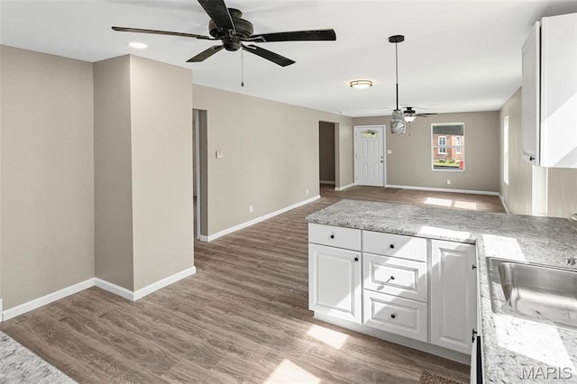 1129 E 7th St, Alton, IL 62002 - kitchen featuring ceiling fan, white cabinetry, open floor plan, light wood-style floors, and baseboards