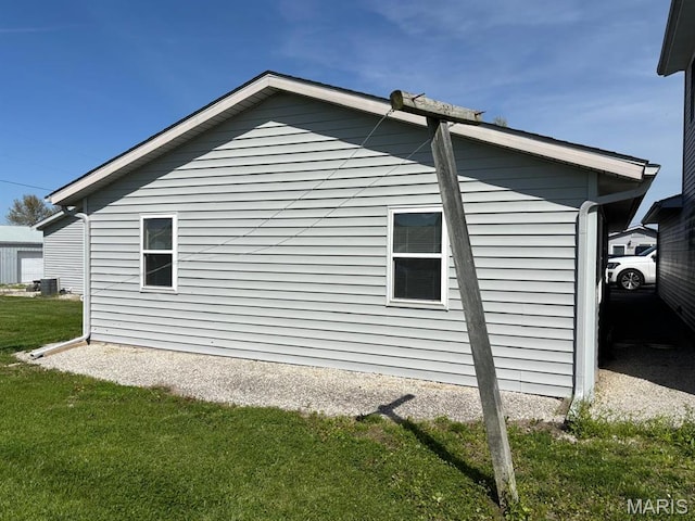 view of property exterior featuring a yard and central AC
