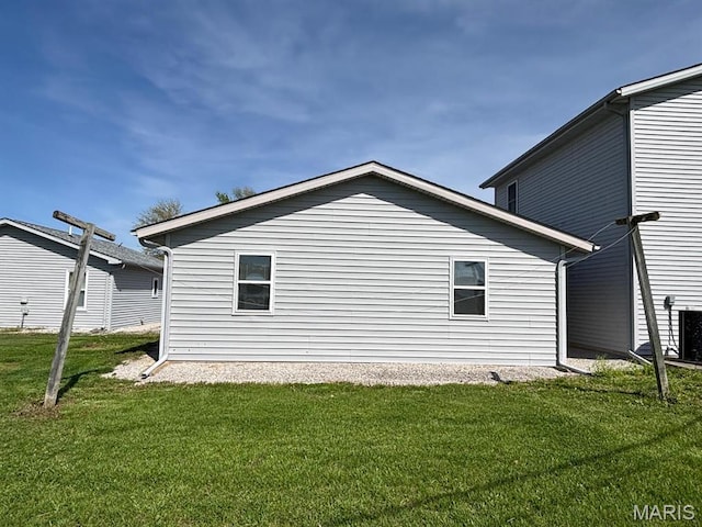 view of side of home with a yard