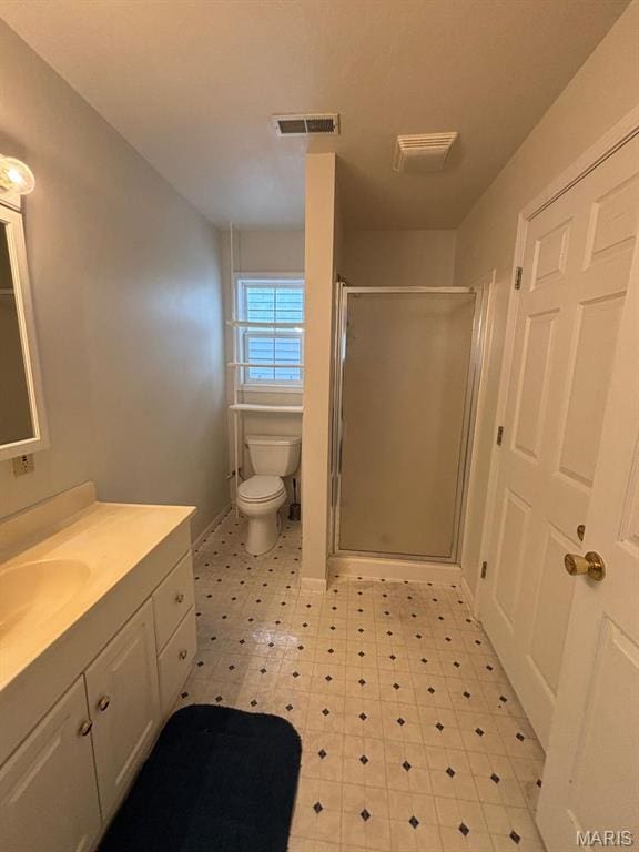 full bath featuring tile patterned floors, toilet, a shower stall, and vanity