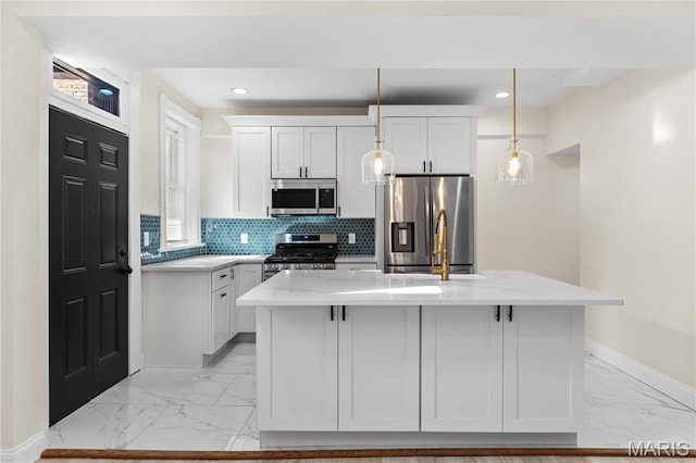 kitchen with appliances with stainless steel finishes, light marble finish flooring, baseboards, decorative light fixtures, and decorative backsplash