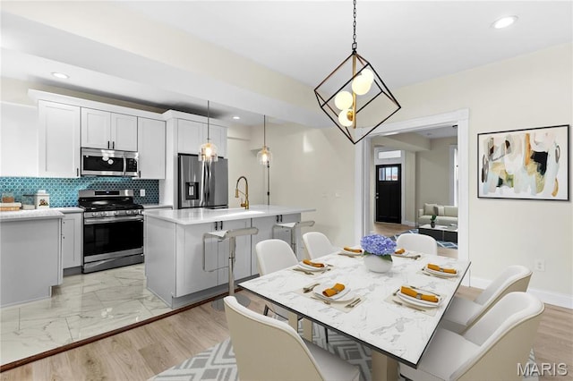 dining area featuring recessed lighting, a chandelier, and baseboards