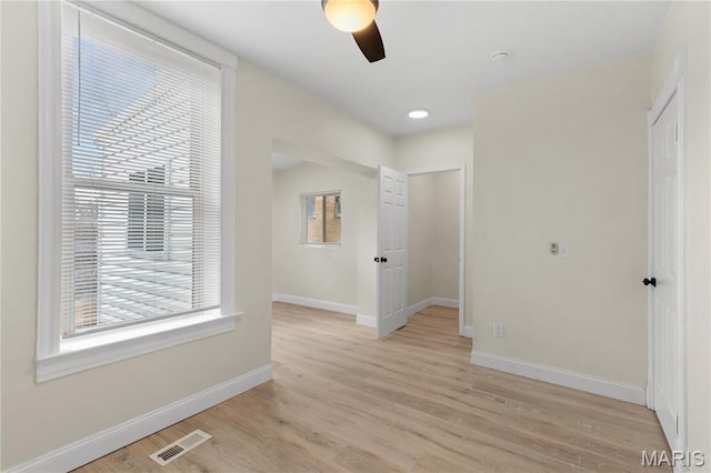 hall with baseboards and light wood-style flooring