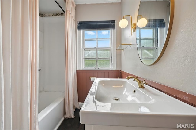 923 S Hanley Rd Unit A, Saint Louis, MO 63105 - bathroom featuring wainscoting, shower / bath combo, and vanity